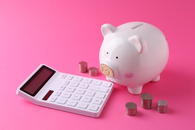 Financial savings. Piggy bank, coins and calculator on pink background