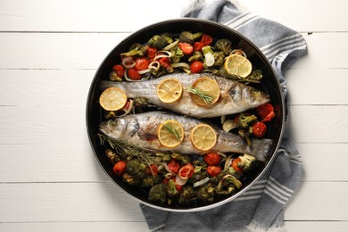 Photo of Baked fish with vegetables, rosemary and lemon on white wooden table, top view