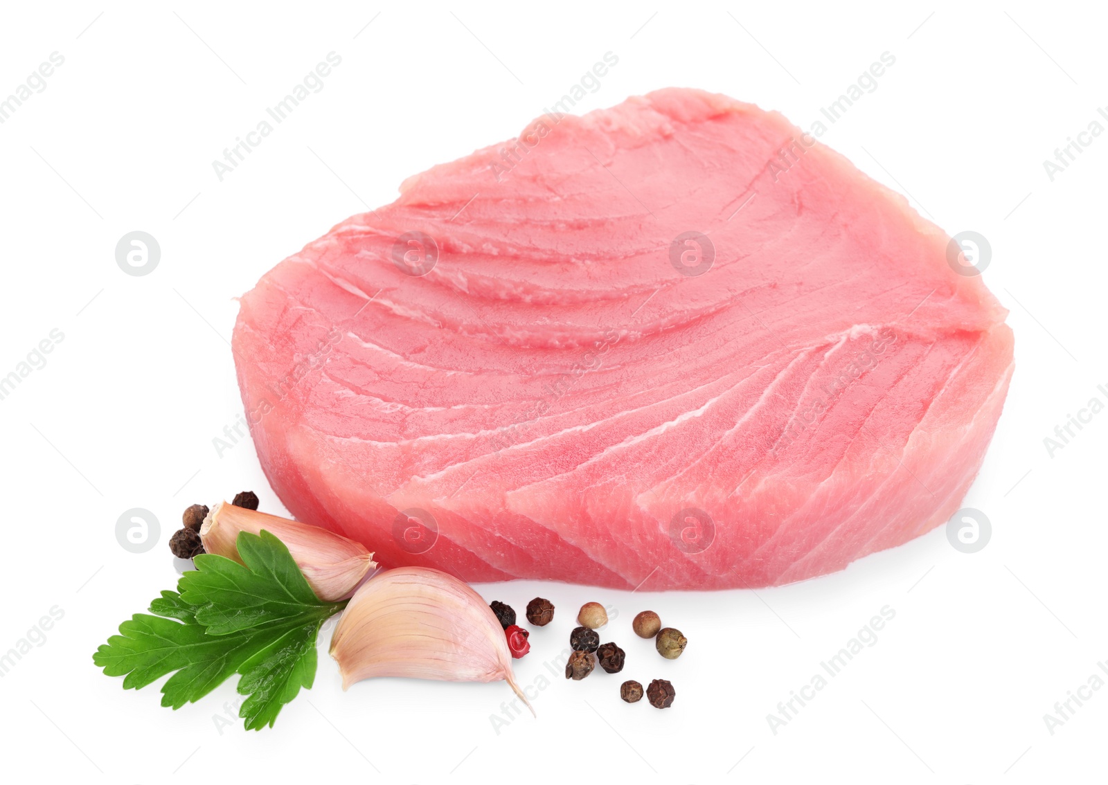 Photo of Raw tuna fillet and spices on white background