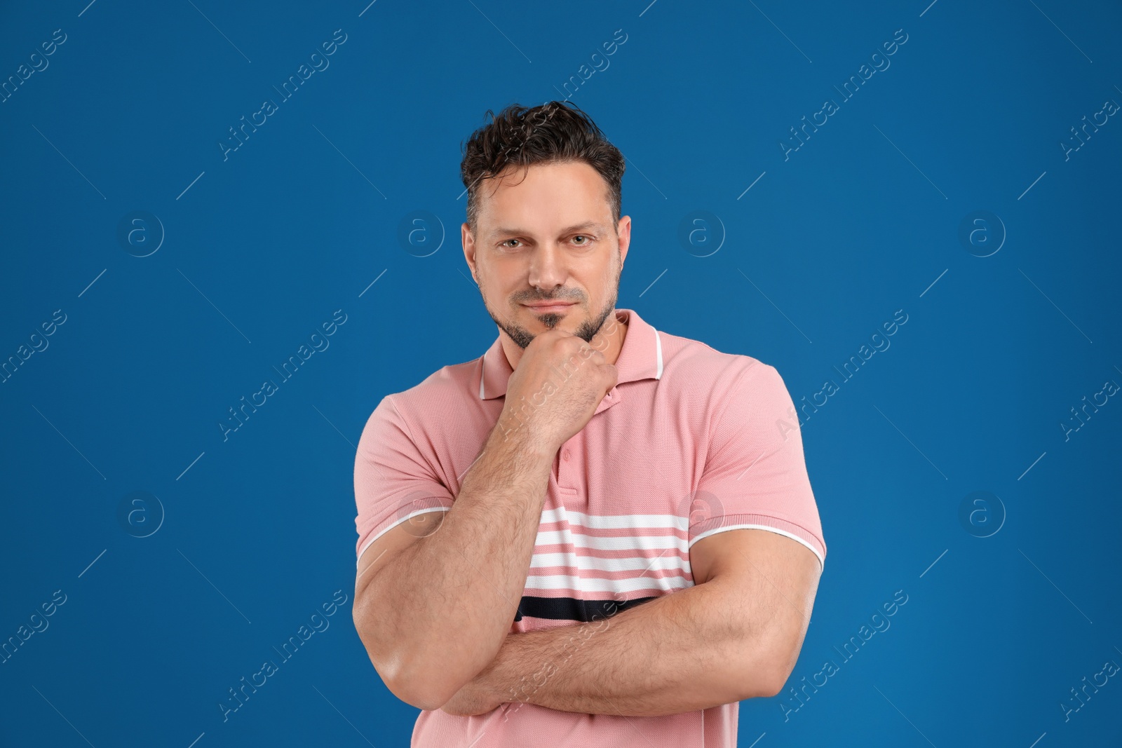 Photo of Portrait of handsome man on dark blue background