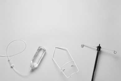 Photo of IV infusion set on light grey background, flat lay. Space for text