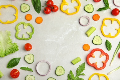 Photo of Frame made with fresh salad ingredients on white wooden table, flat lay. Space for text