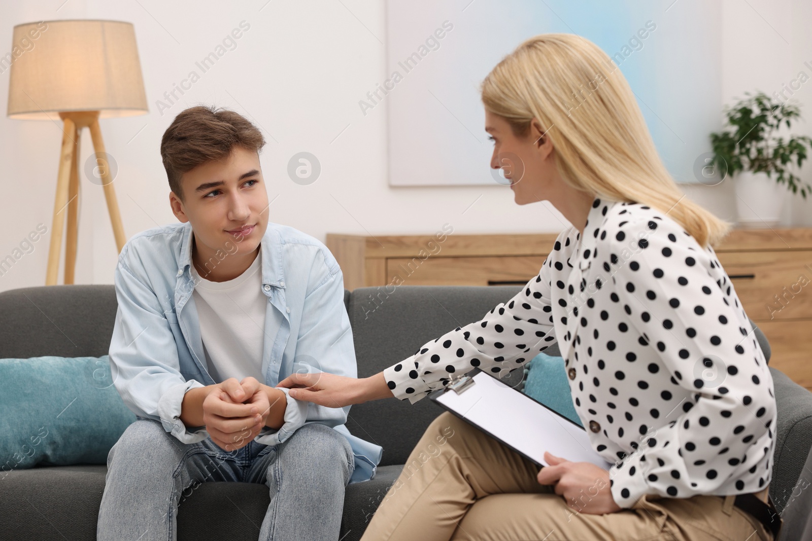 Photo of Psychologist working with teenage boy in office