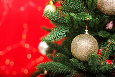 Photo of Decorated fir tree against blurred Christmas lights