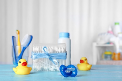 Baby accessories and toys on table against light background. Space for text