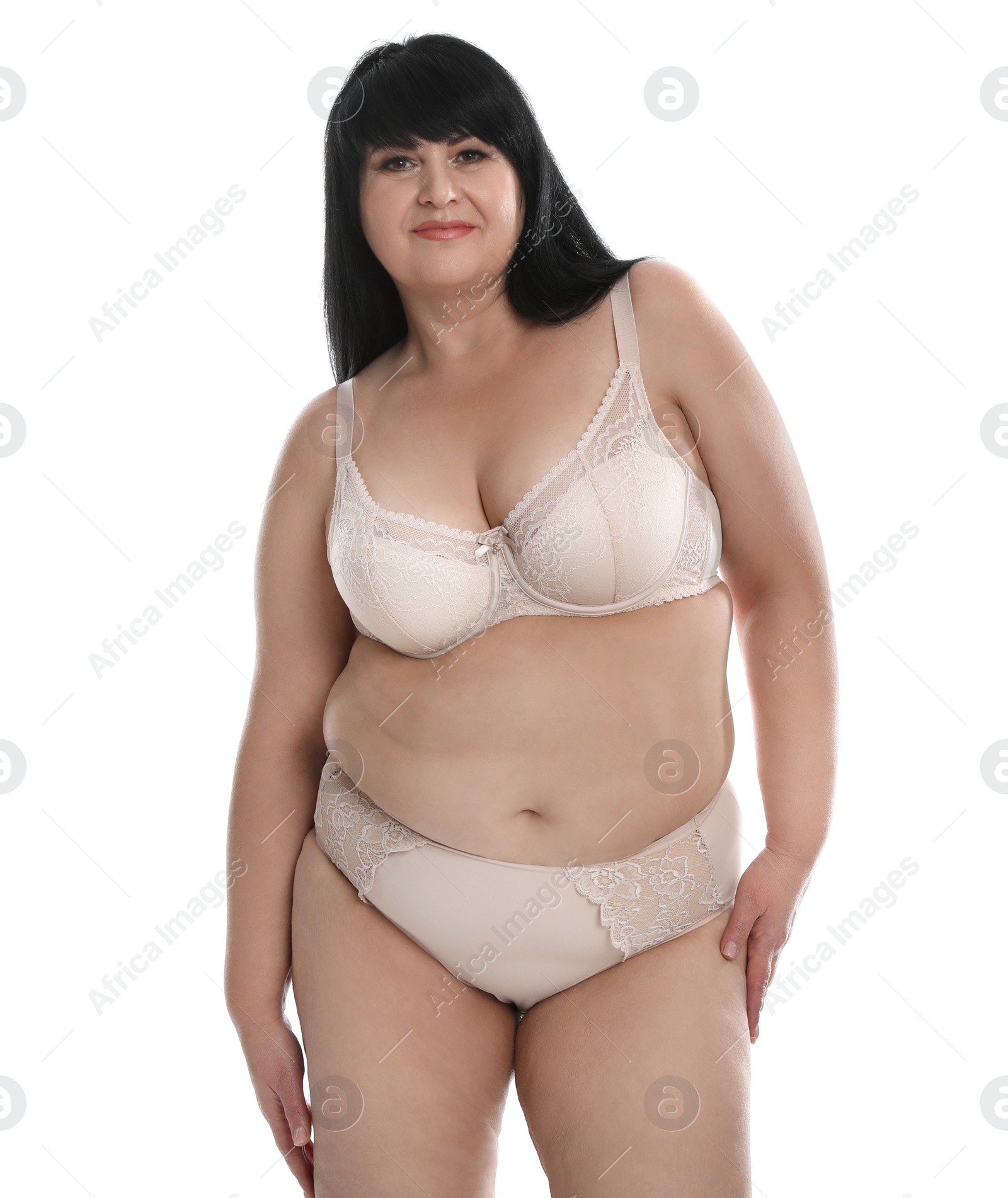 Photo of Beautiful overweight woman in beige underwear on white background. Plus-size model