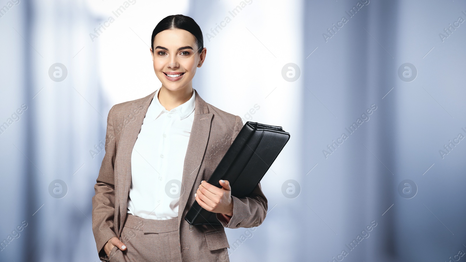 Image of Beautiful real estate agent with portfolio in office, space for text