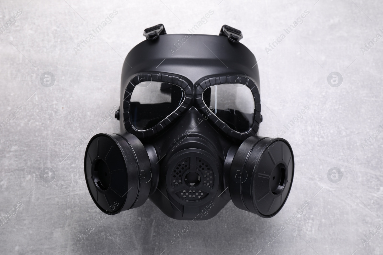 Photo of One gas mask on grey textured background, top view