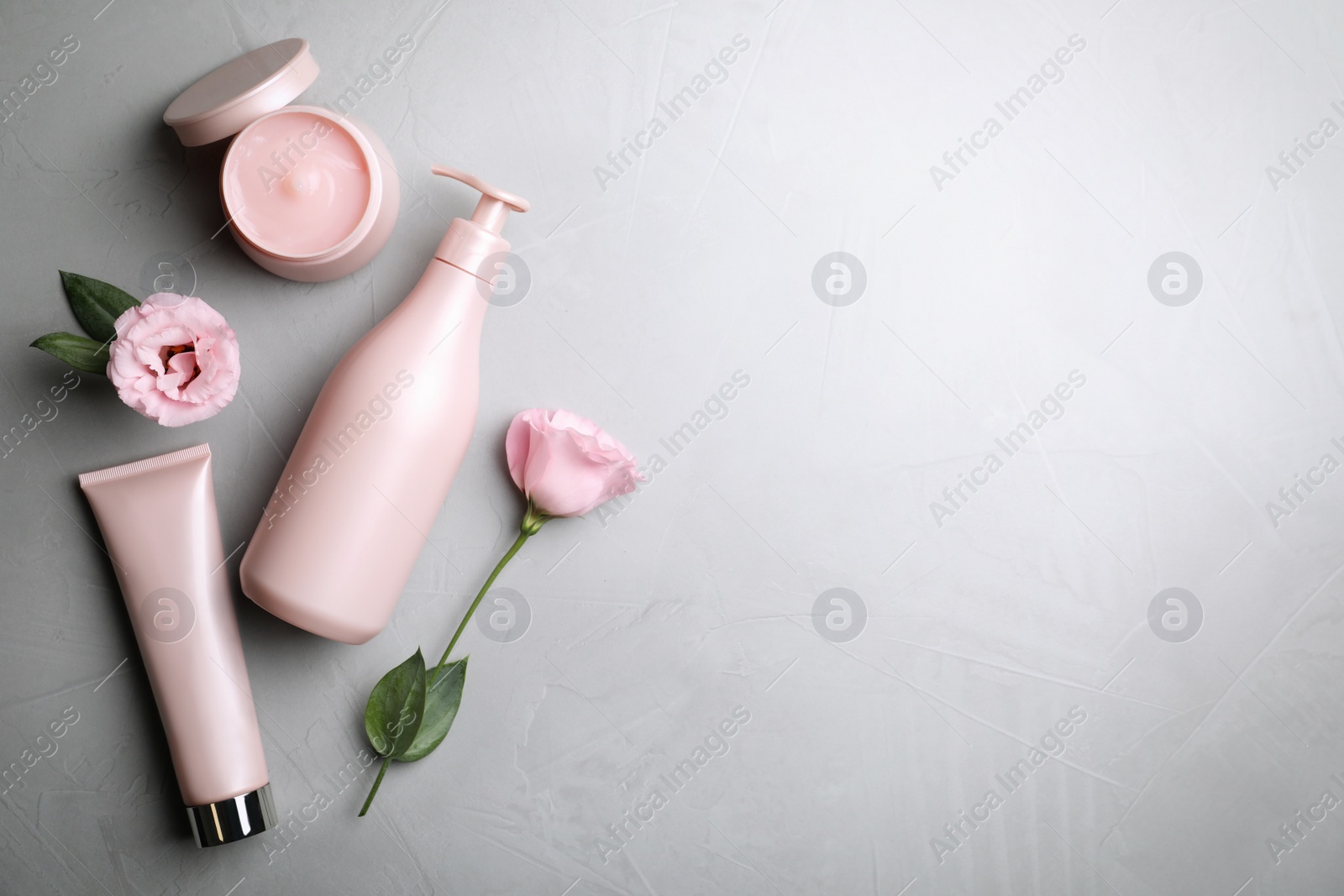 Photo of Flat lay composition with hair cosmetic products on grey stone table