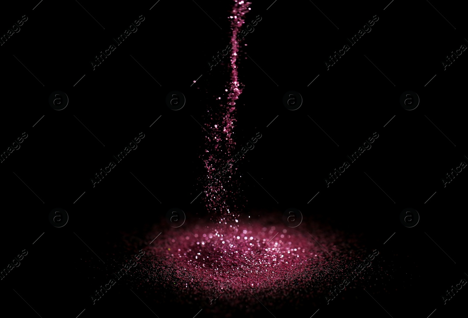 Photo of Sprinkling rose glitter on black background, bokeh effect