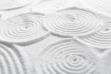 Photo of Zen rock garden. Circle patterns on white sand, closeup