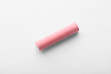 Photo of Small piece of pink chalk isolated on white, top view