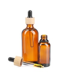 Photo of Glass bottles and pipette with tincture isolated on white