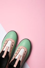 Flat lay composition of stylish shoes on color background, space for text