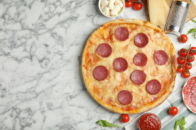 Flat lay composition with tasty pepperoni pizza on white marble table. Space for text