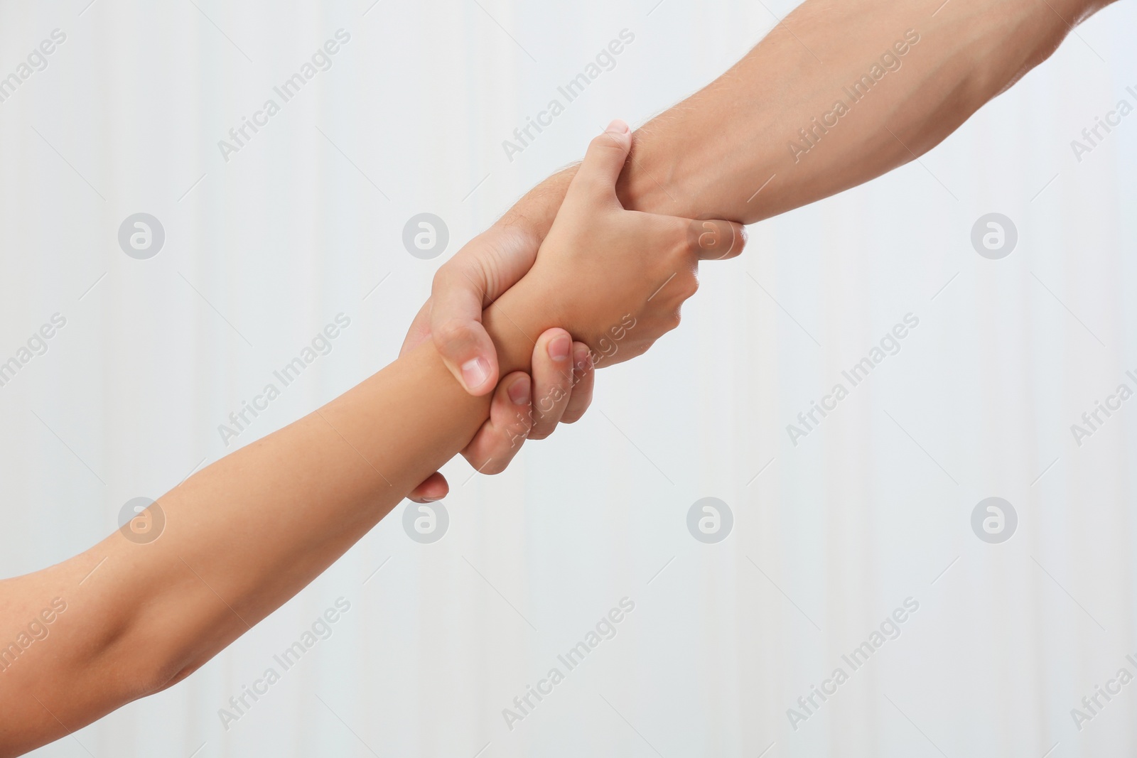 Photo of People holding hands together on light background. Concept of support and help