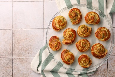 Fresh delicious puff pastry with tasty filling on white tiled surface, top view. Space for text