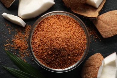 Photo of Flat lay composition with natural coconut sugar on black table