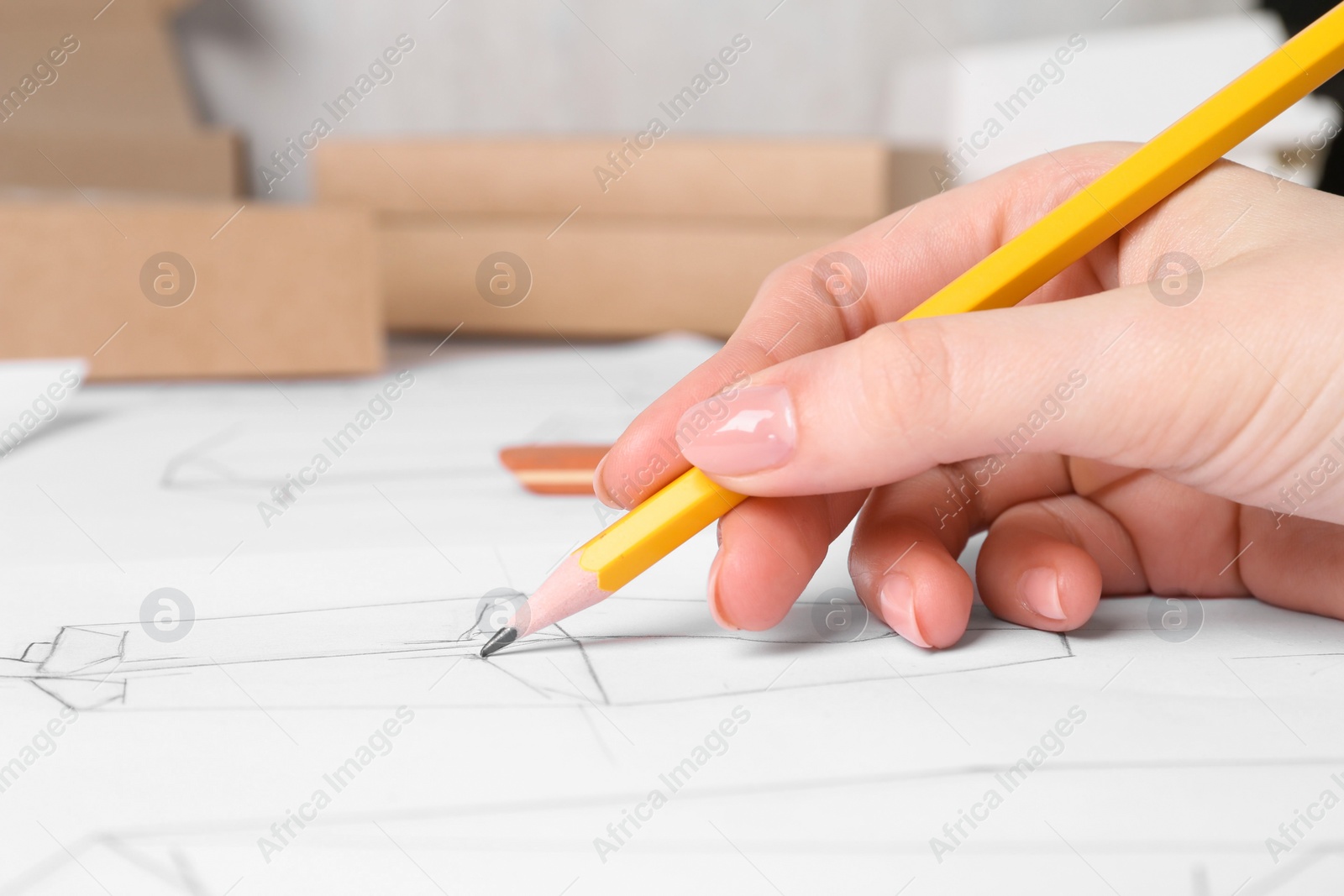 Photo of Woman creating packaging design at table, closeup