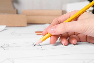 Photo of Woman creating packaging design at table, closeup