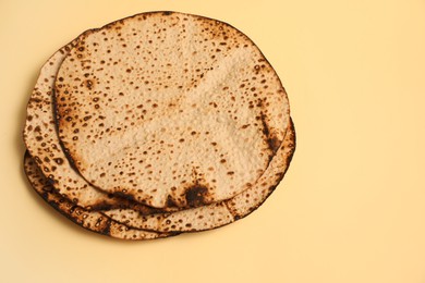 Tasty matzos on beige background, above view. Passover (Pesach) celebration