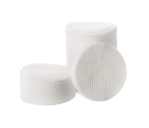 Photo of Piles of cotton pads on white background
