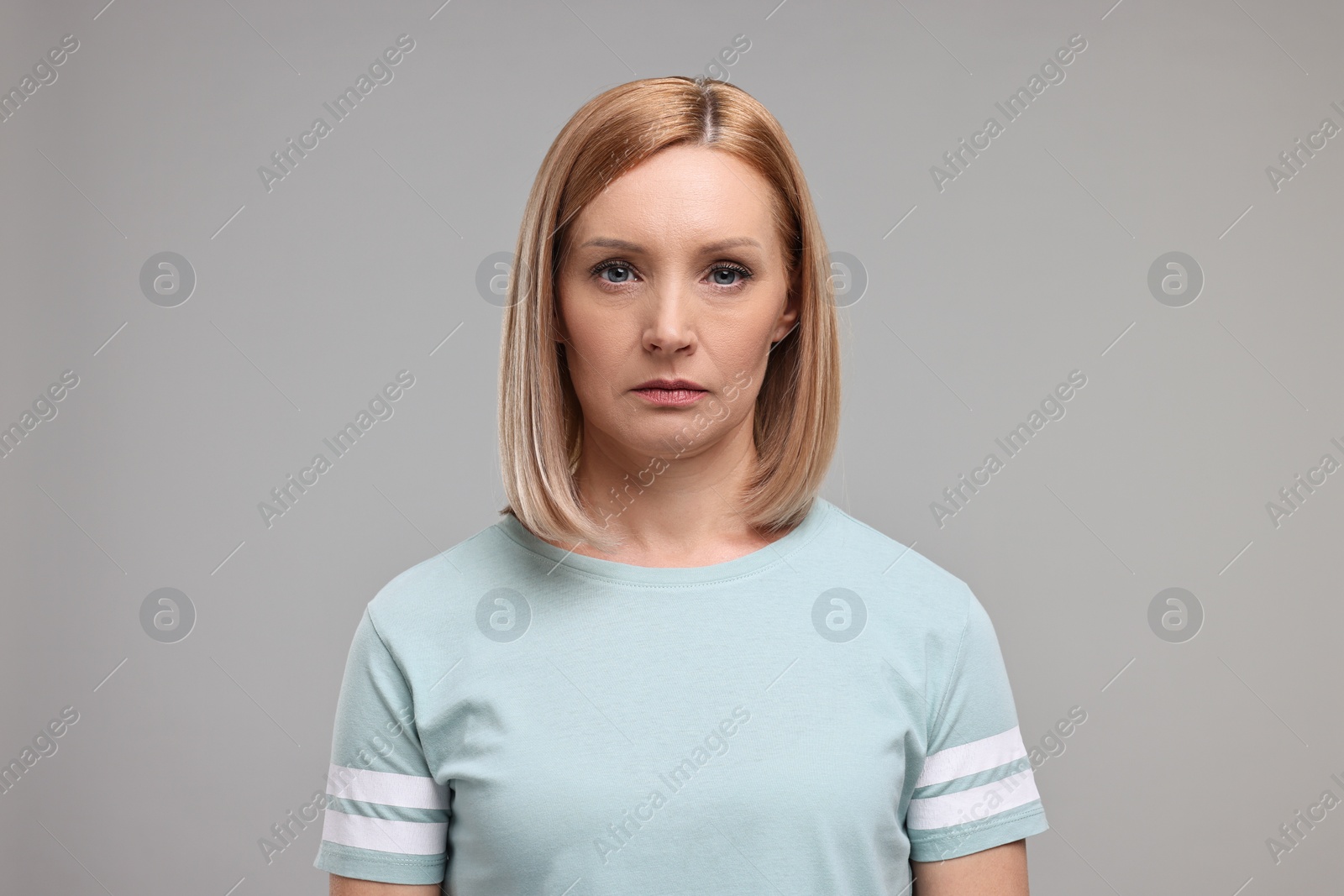 Photo of Portrait of sad woman on grey background