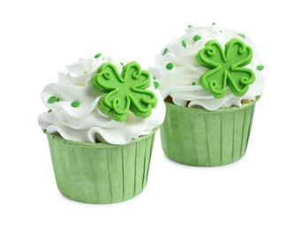 Photo of St. Patrick's day party. Tasty cupcakes with green clover leaf toppers and sprinkles isolated on white