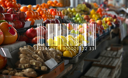Image of Barcode and tasty fresh fruits on counter at wholesale market