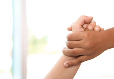 Photo of Children holding hands on blurred background, closeup. Unity concept