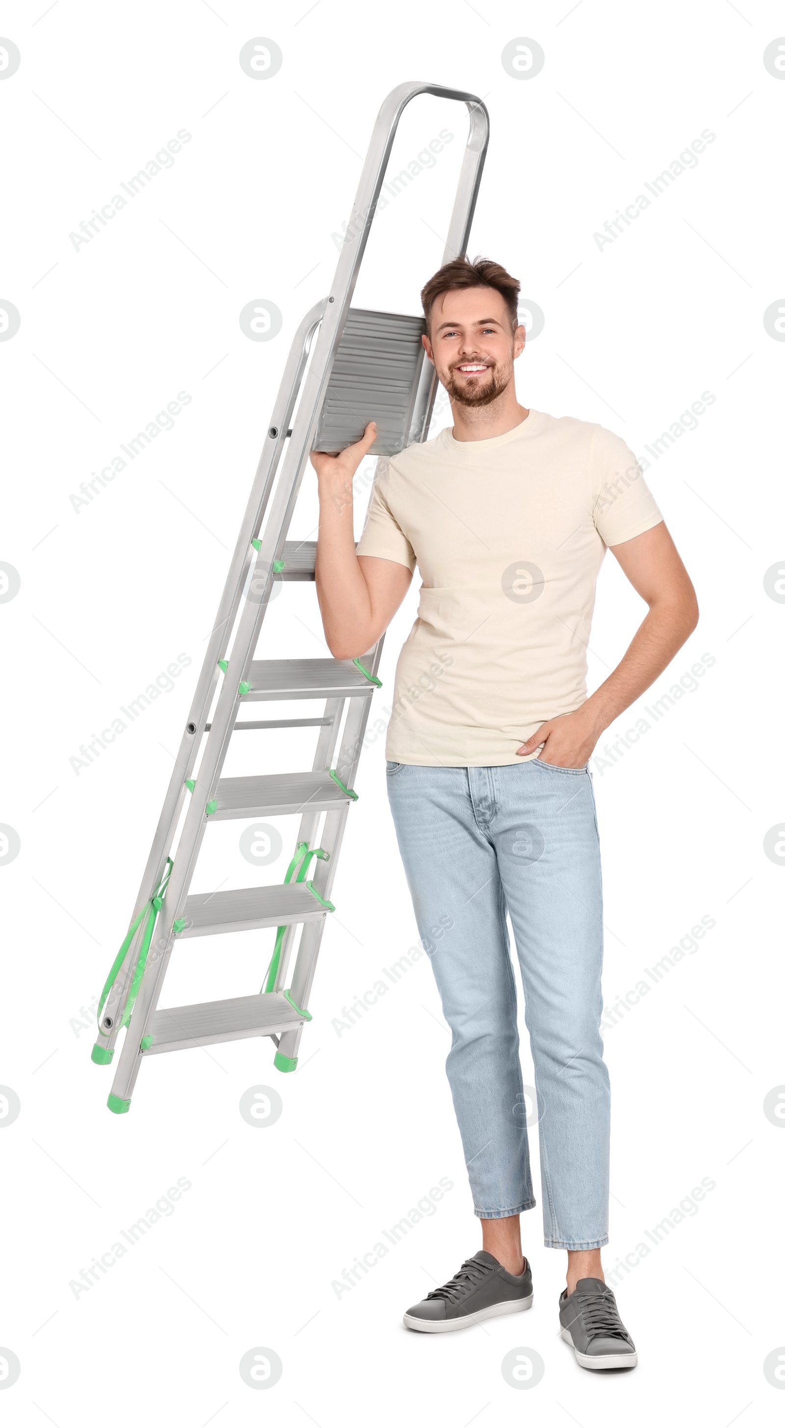 Photo of Young handsome man holding metal ladder on white background
