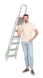 Photo of Young handsome man holding metal ladder on white background