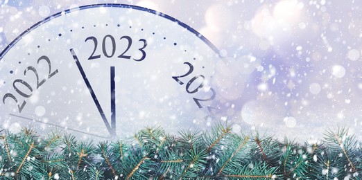 Image of Clock counting last moments to New 2023 Year and beautiful fir branches, banner design. Bokeh effect