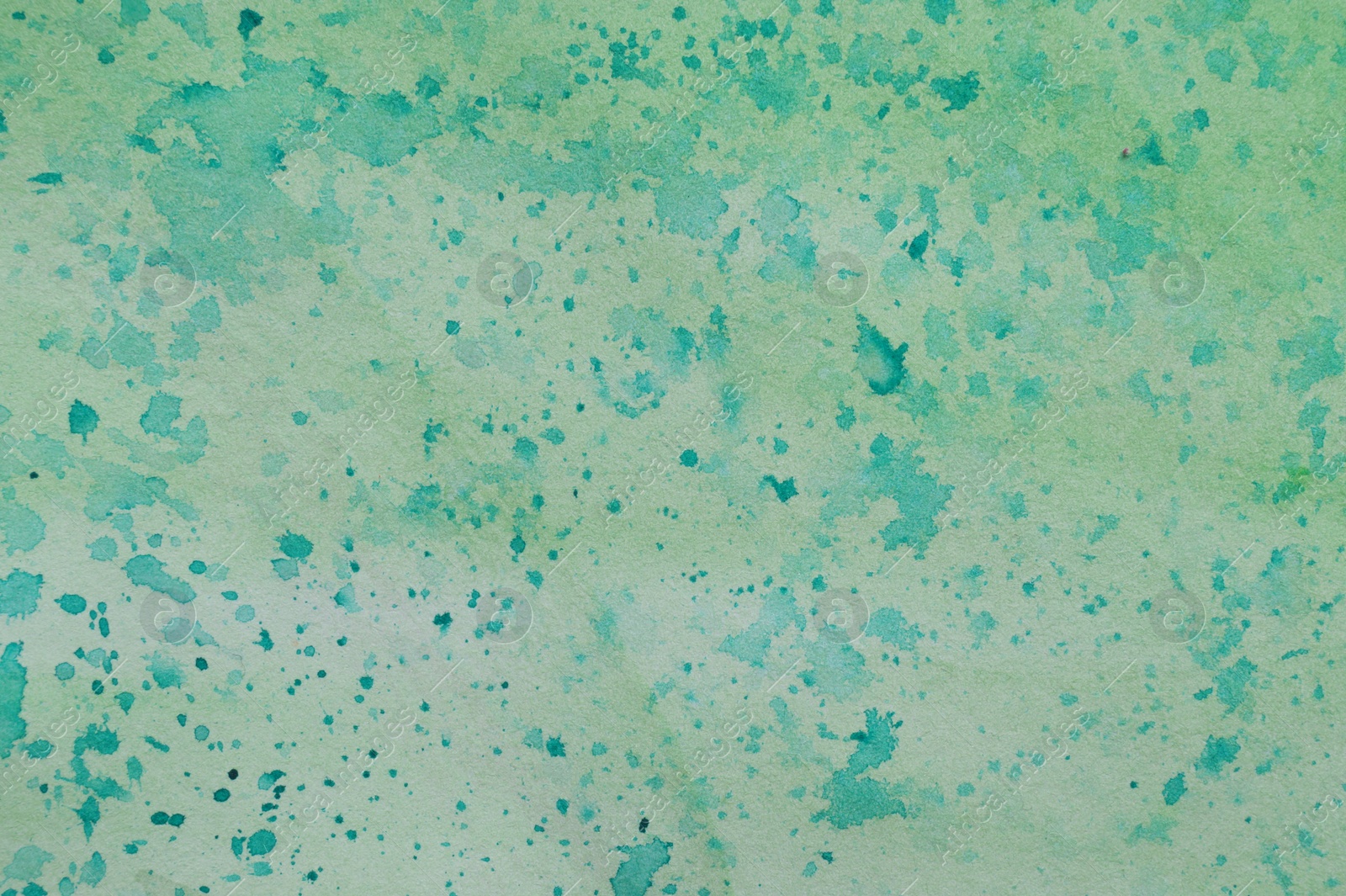 Photo of Abstract watercolor painting with green blots as background, top view