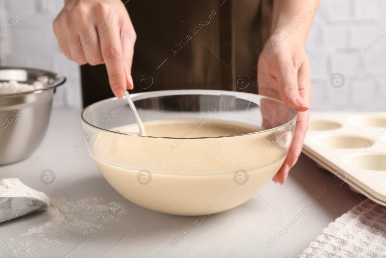 Photo of Woman making batter at light table, closeup