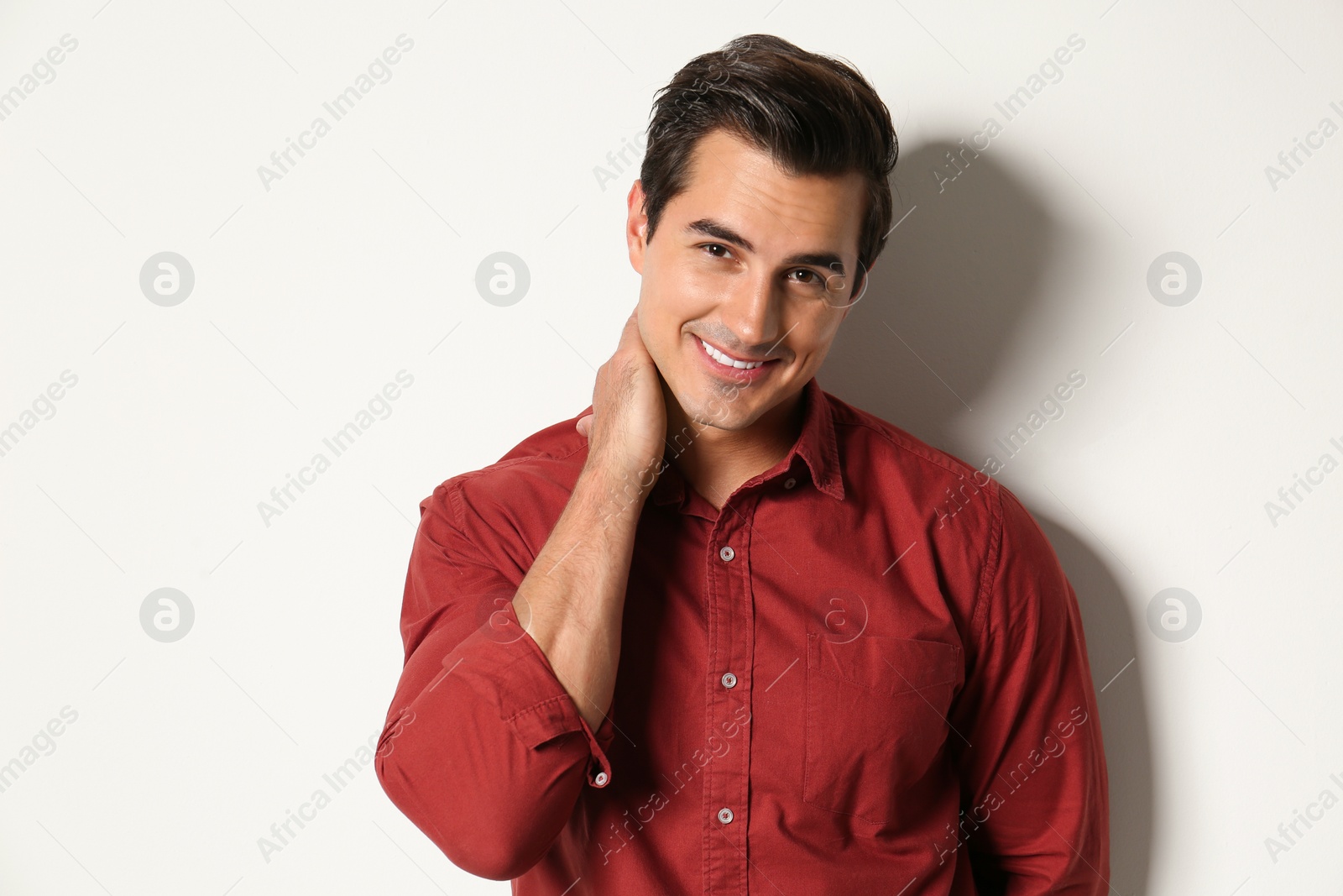 Photo of Handsome young man in stylish clothes on light beige background
