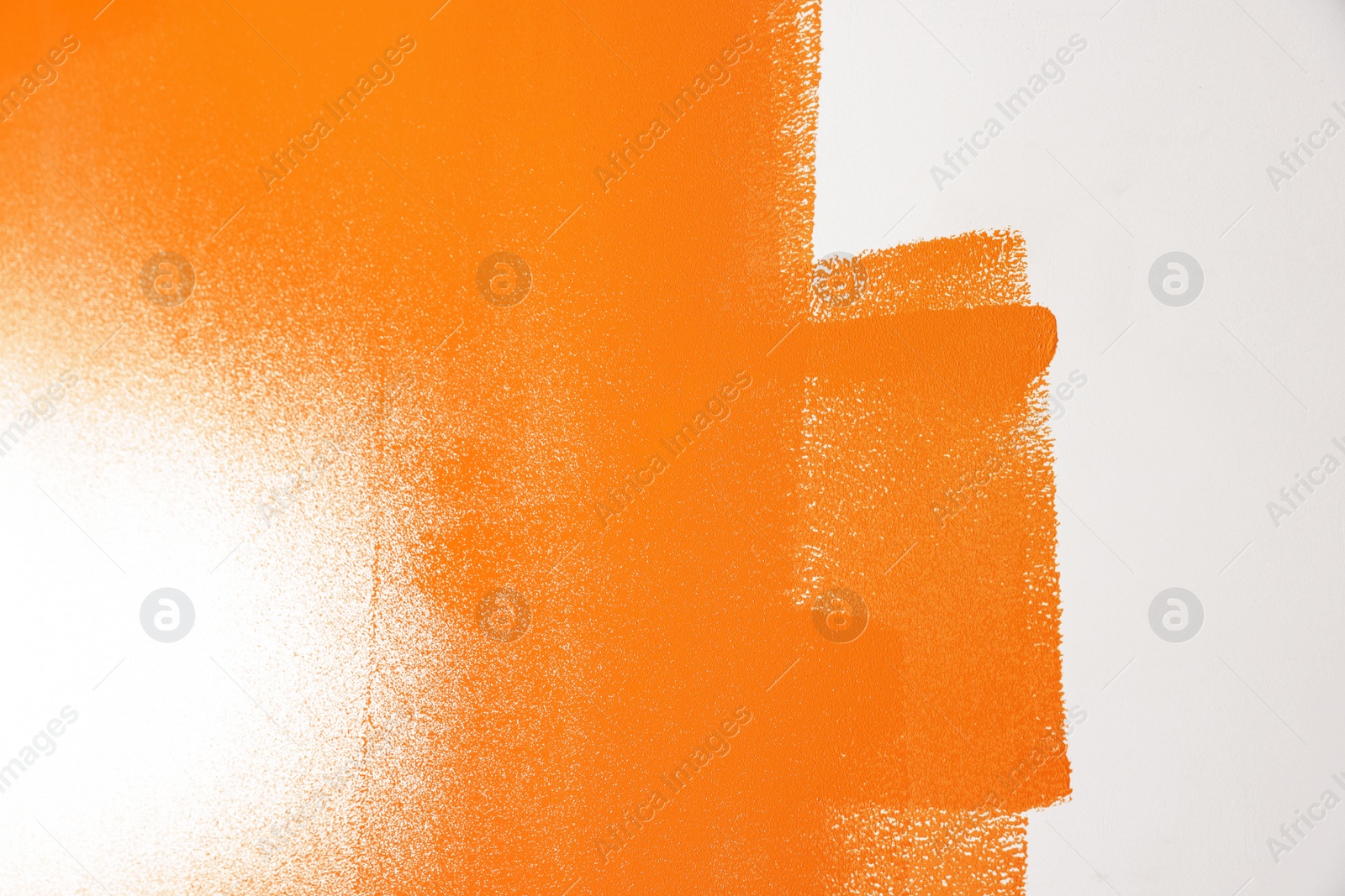 Photo of Wall painted with orange dye, closeup view