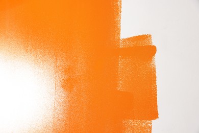 Wall painted with orange dye, closeup view