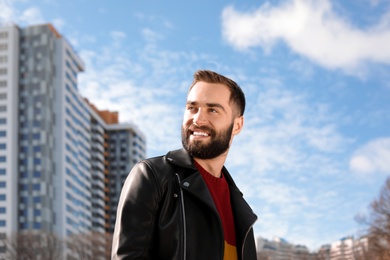 Portrait of stylish young man on city street