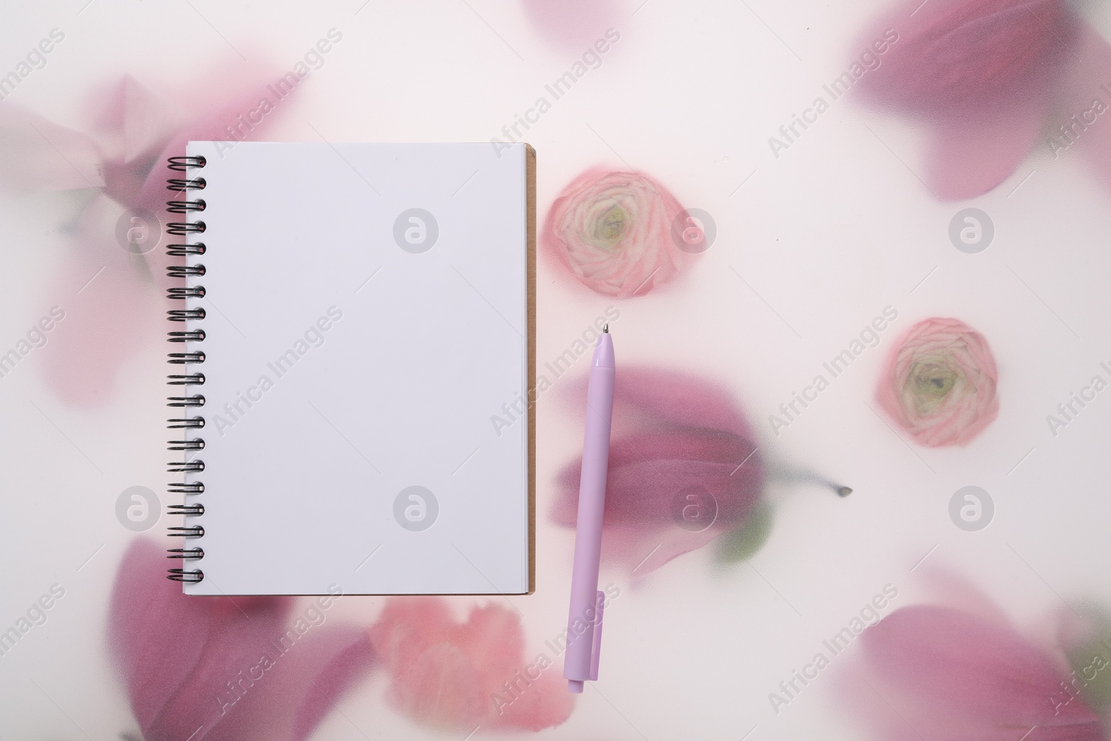 Photo of Guest list. Notebook and pen on spring floral background, flat lay. Space for text