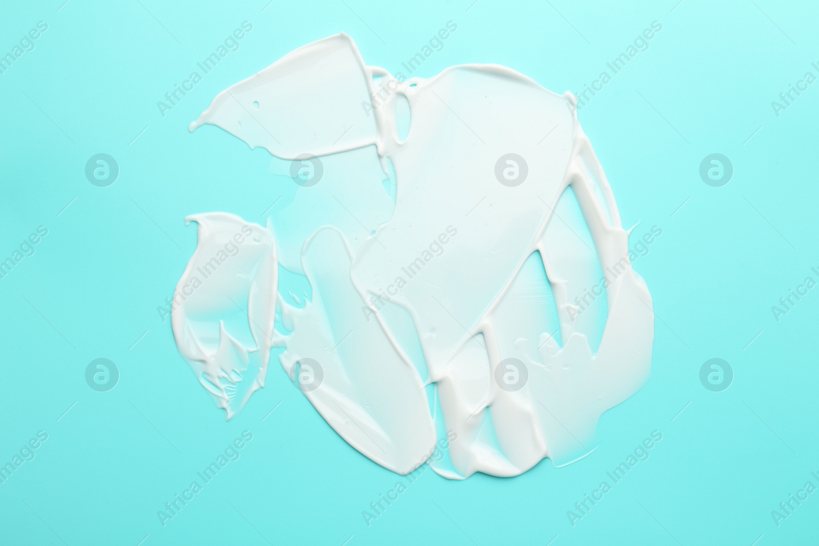 Photo of Face cream on light blue background, top view