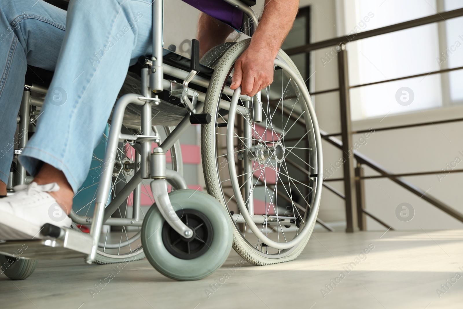 Photo of Senior man sitting in wheelchair indoors, closeup