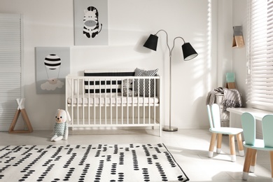 Cute baby room interior with crib and decor elements