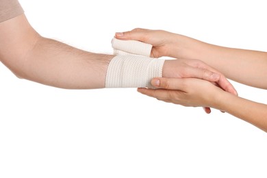 Photo of Doctor applying medical bandage onto patient's hand on white background, closeup