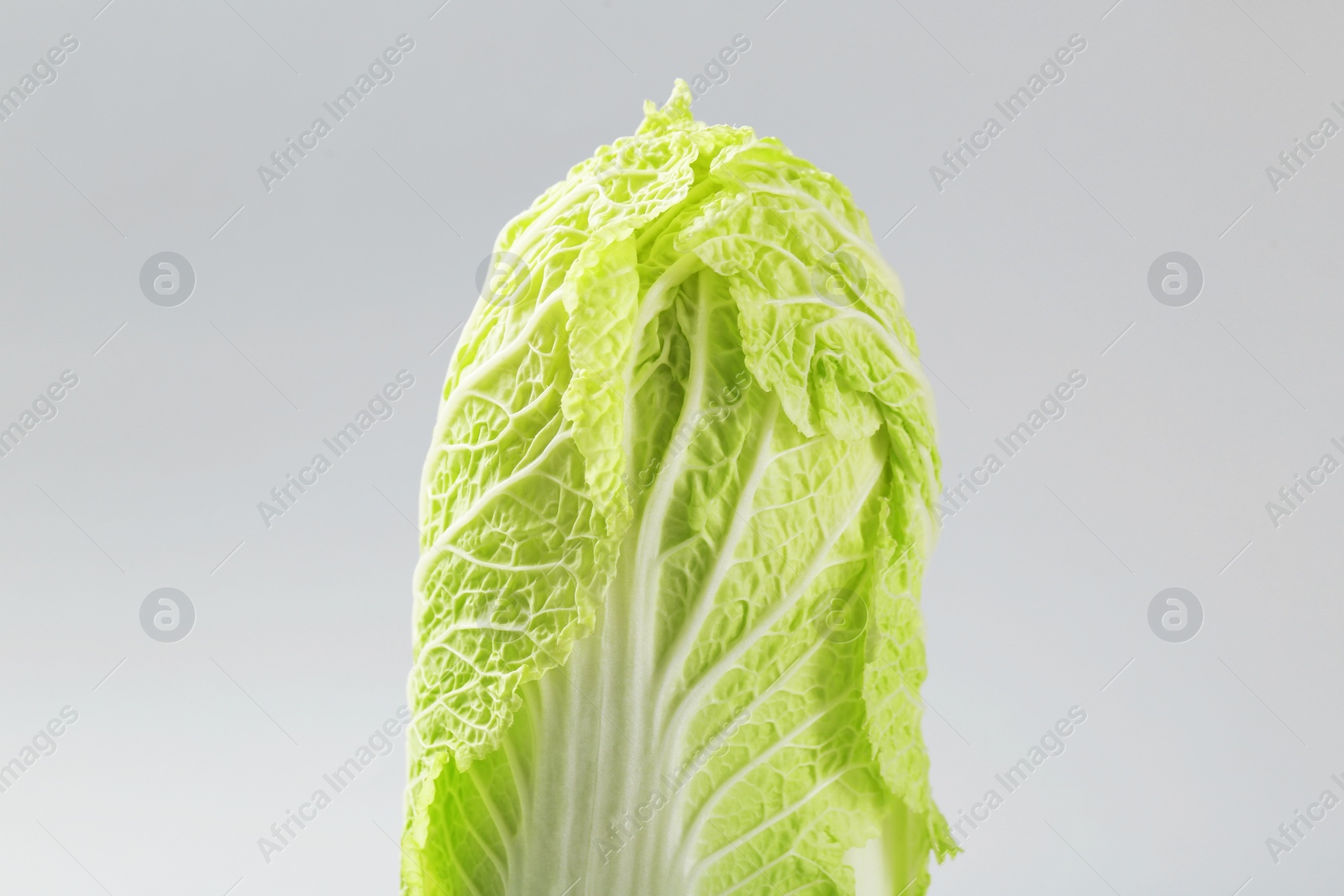 Photo of Fresh ripe Chinese cabbage on light grey background, closeup