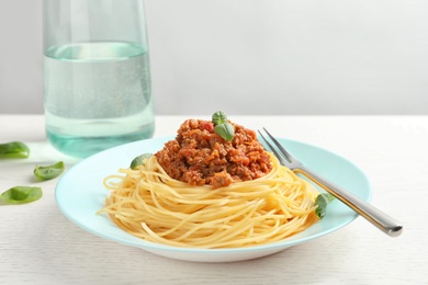 Plate with delicious pasta bolognese on table