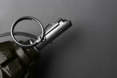 Photo of Hand grenade on grey background, closeup. Space for text