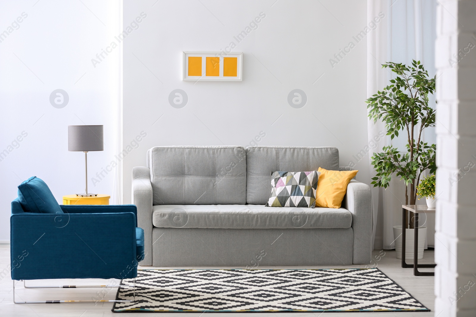 Photo of Stylish living room interior with comfortable sofa and armchair