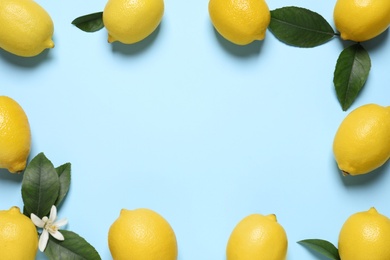 Photo of Frame of fresh ripe lemons on light blue background, flat lay. Space for text