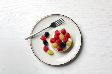 Photo of Delicious tartlet with berries on white wooden table, top view